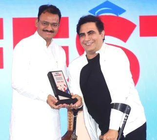 Dr. Arvinder Singh receiving an award from the Deputy Chief Minister of Rajasthan