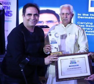 Dr. Arvinder Singh receiving recognition from the Health Minister of Rajasthan